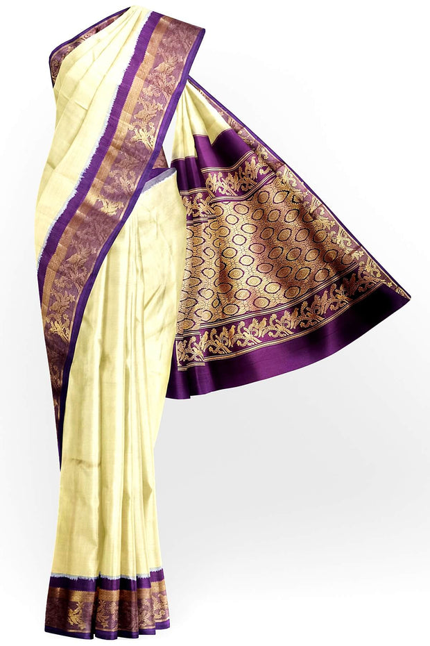 Handwoven Kanchi pure silk saree in off white and a contrast pallu in purple.