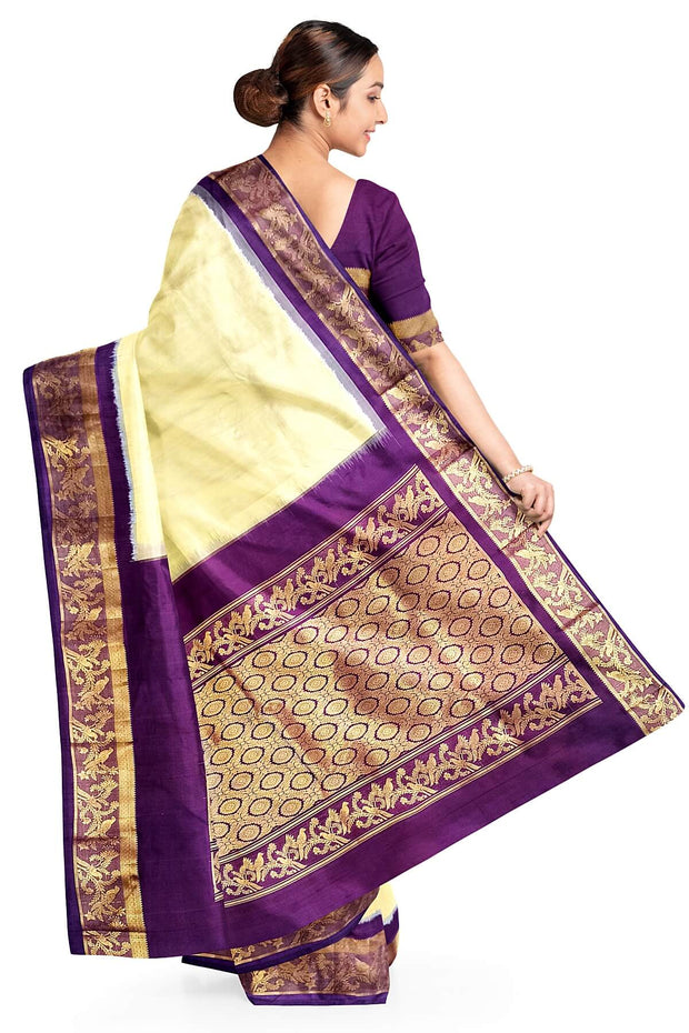 Handwoven Kanchi pure silk saree in off white and a contrast pallu in purple.