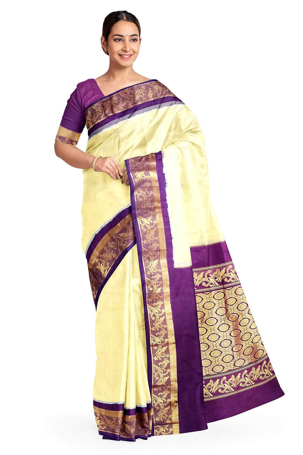 Handwoven Kanchi pure silk saree in off white and a contrast pallu in purple.