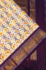 Handwoven Ikkat pure silk saree in off white with floral vines .