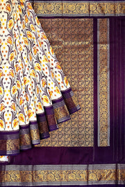 Handwoven Ikkat pure silk saree in off white with floral vines .