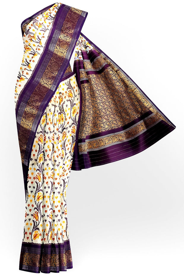 Handwoven Ikkat pure silk saree in off white with floral vines .