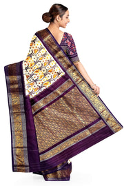 Handwoven Ikkat pure silk saree in off white with floral vines .