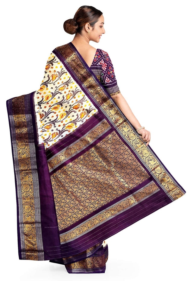 Handwoven Ikkat pure silk saree in off white with floral vines .