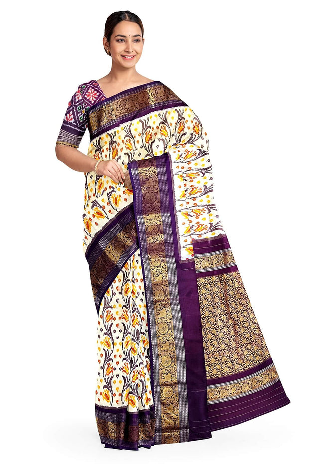 Handwoven Ikkat pure silk saree in off white with floral vines .