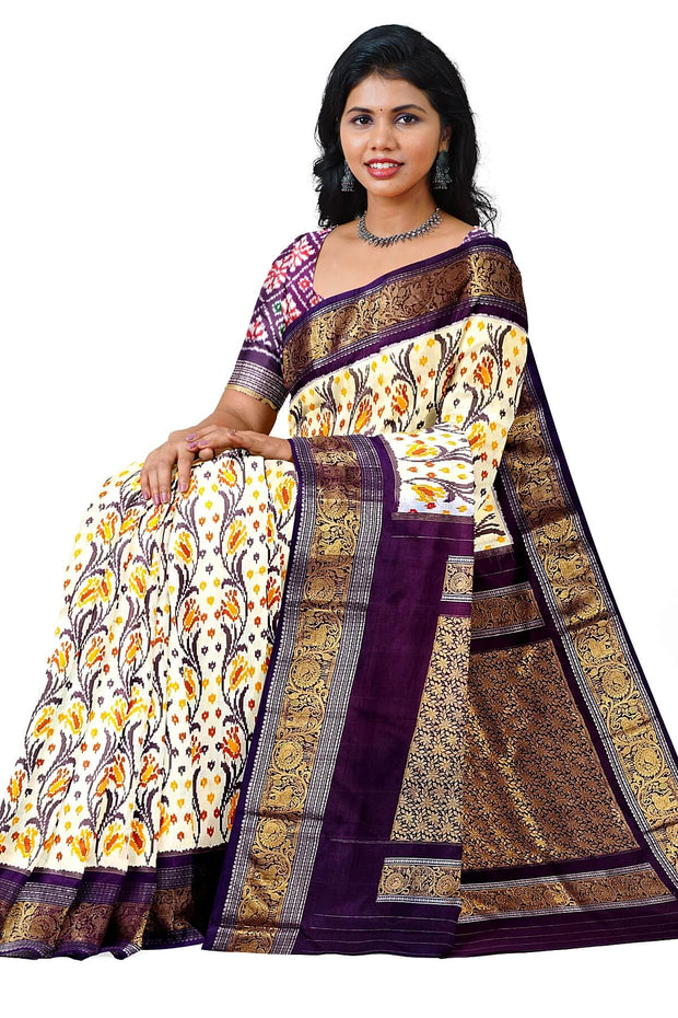 Handwoven Ikkat pure silk saree in off white with floral vines .