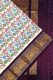 Handwoven Ikkat pure silk saree in  white with floral pattern