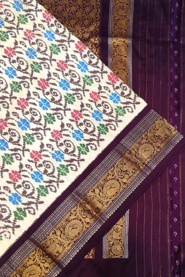 Handwoven Ikkat pure silk saree in  white with floral pattern