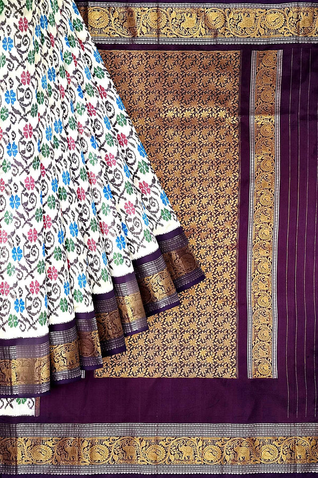Handwoven Ikkat pure silk saree in  white with floral pattern