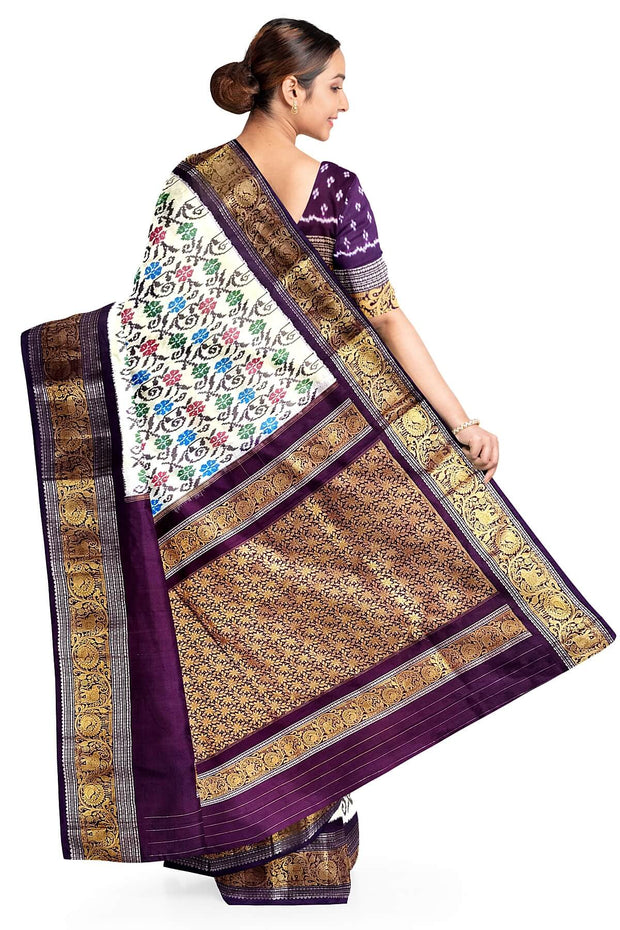 Handwoven Ikkat pure silk saree in  white with floral pattern