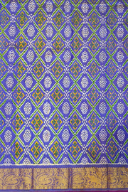 Handwoven Ikkat weave on a  fine zari striped pure silk saree in berry blue .