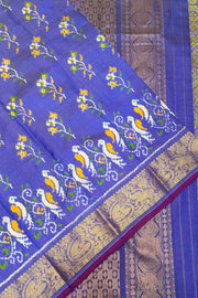 Handwoven Ikkat weave on a  fine zari striped pure silk saree in berry blue .