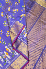 Handwoven Ikkat weave on a  fine zari striped pure silk saree in berry blue .