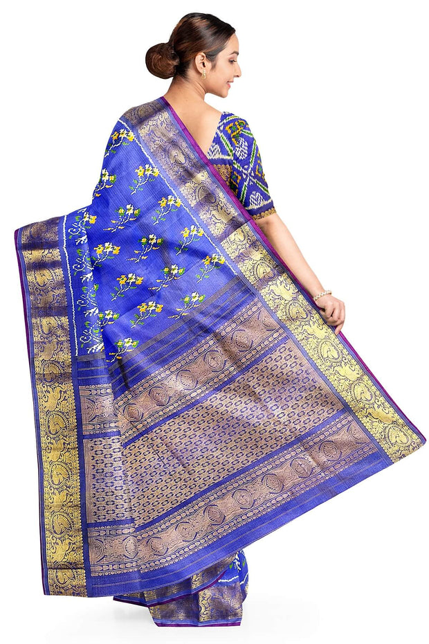 Handwoven Ikkat weave on a  fine zari striped pure silk saree in berry blue .