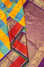 Handwoven ikat pure silk saree in multicolour with zari checks and small floral woven motifs .