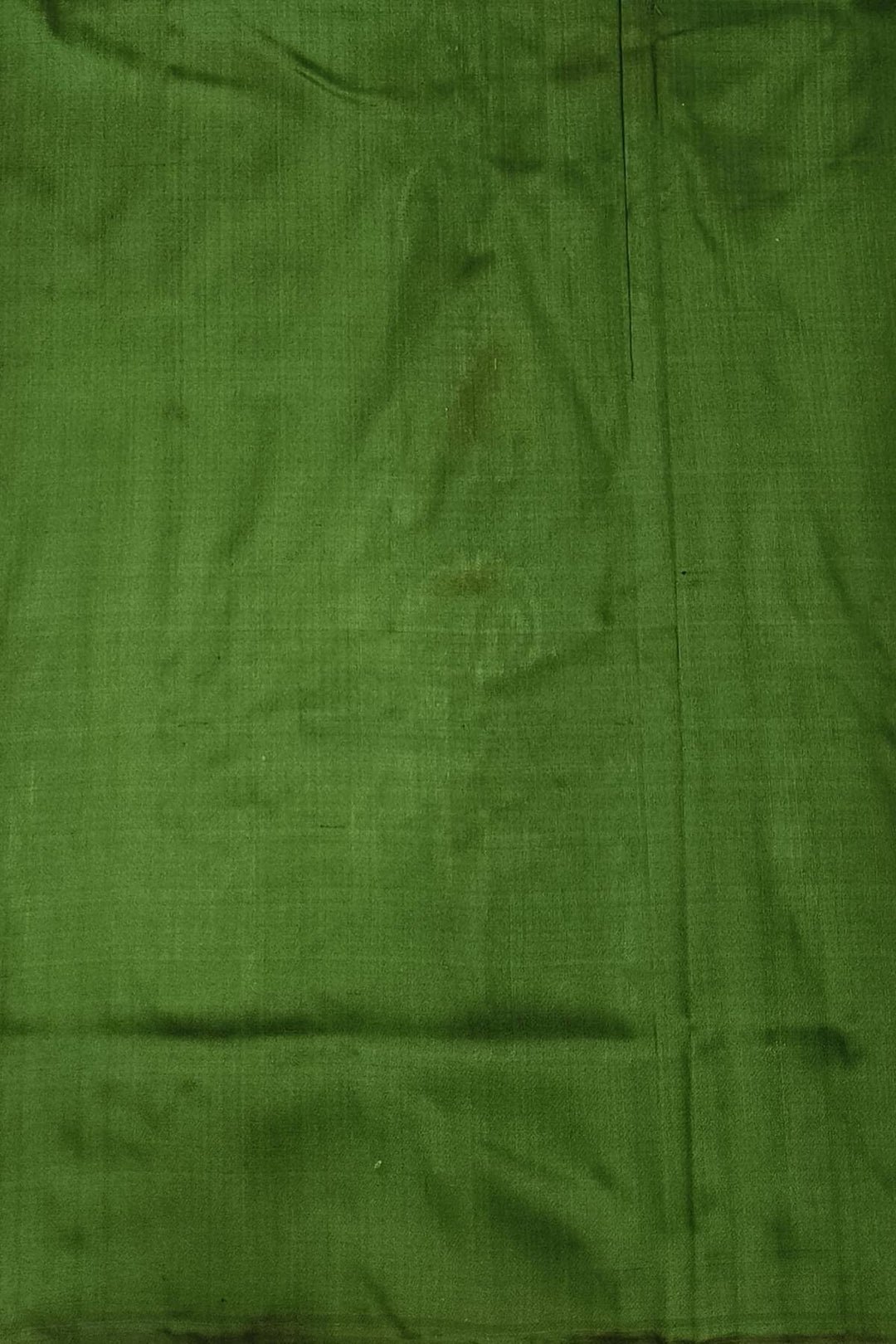 A twill weave ikkat pure silk saree in bottle green