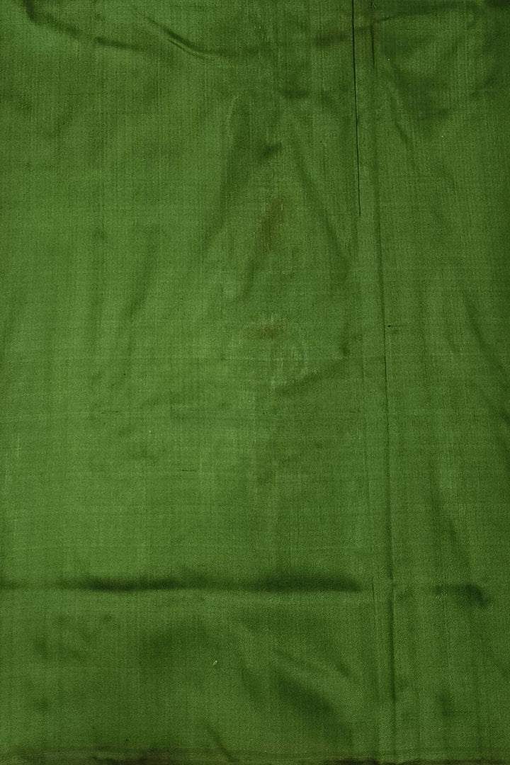 A twill weave ikkat pure silk saree in bottle green