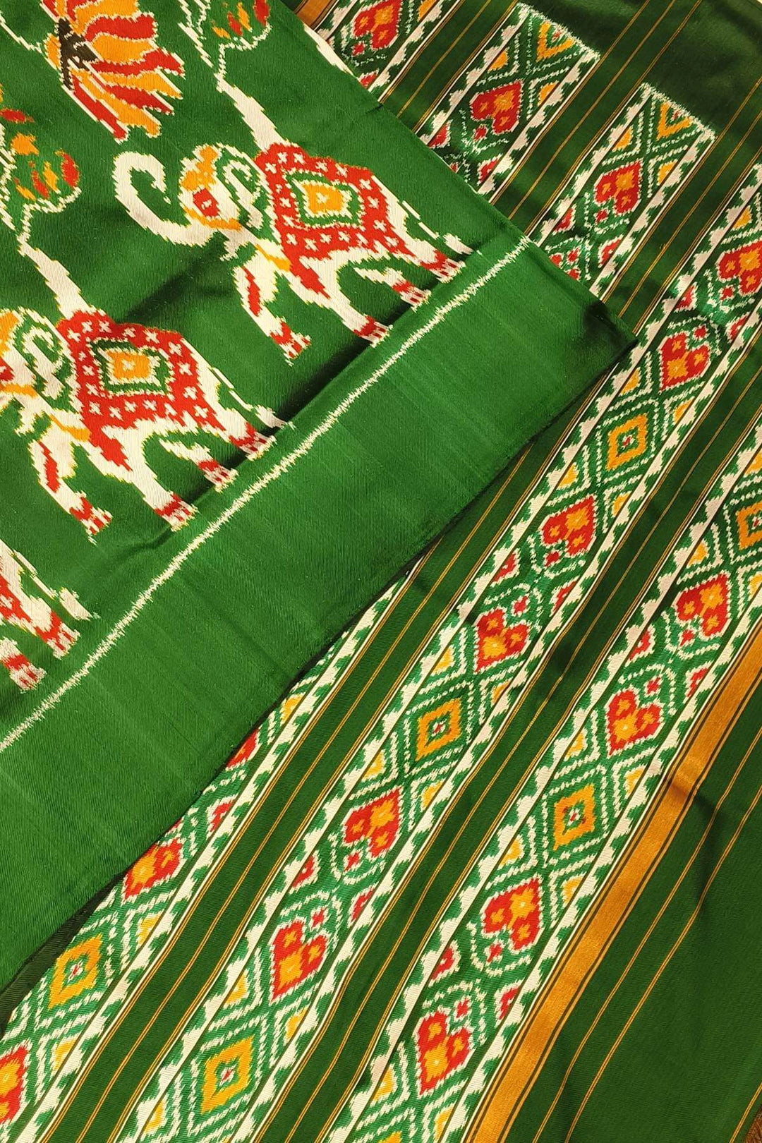 A twill weave ikkat pure silk saree in bottle green