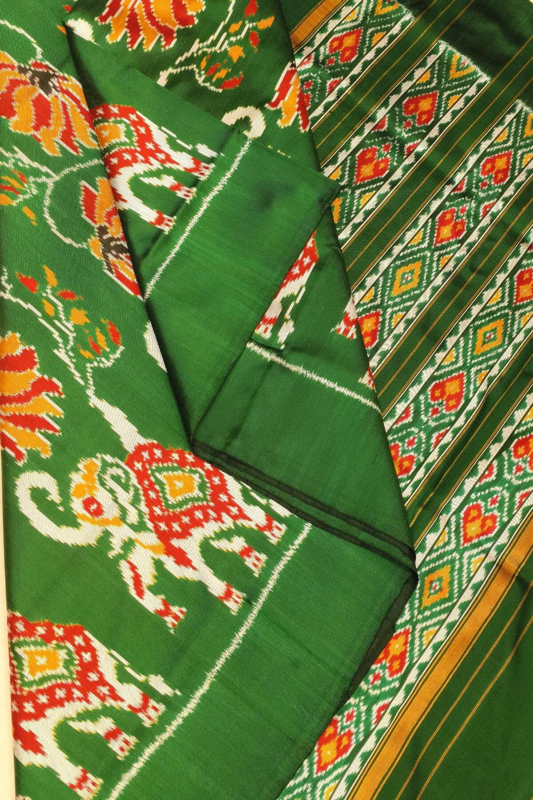 A twill weave ikkat pure silk saree in bottle green