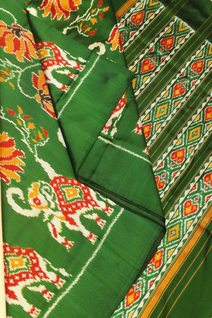 A twill weave ikkat pure silk saree in bottle green