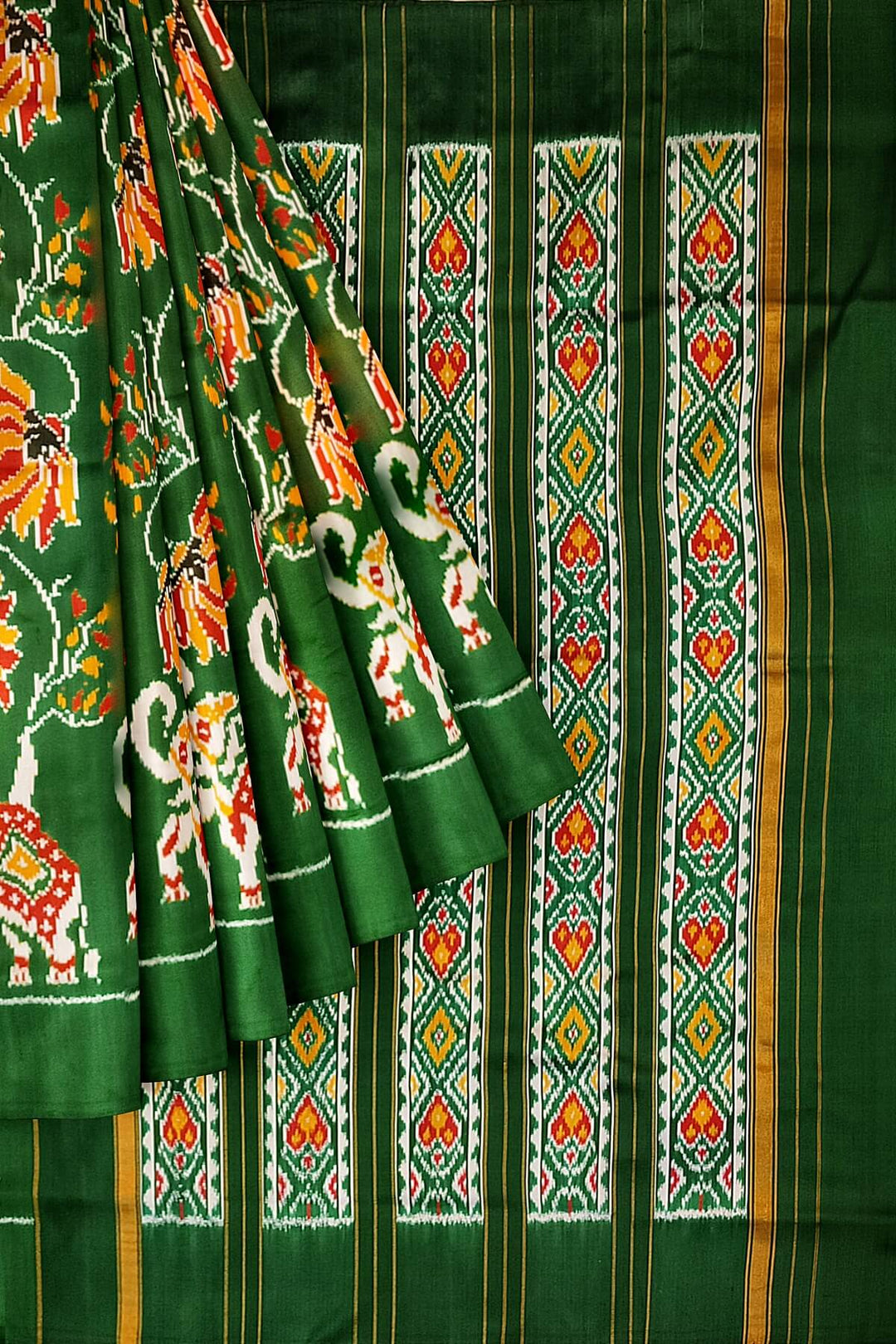 A twill weave ikkat pure silk saree in bottle green