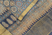 Dola silk saree in blue  with floral motifs in  hand block Ajrakh print .