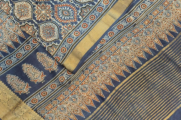 Dola silk saree in blue  with floral motifs in  hand block Ajrakh print .
