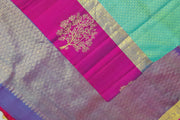 Kanchi silk brocade saree in teal green with floral motifs in border and a rich pallu