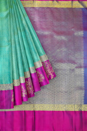 Kanchi silk brocade saree in teal green with floral motifs in border and a rich pallu