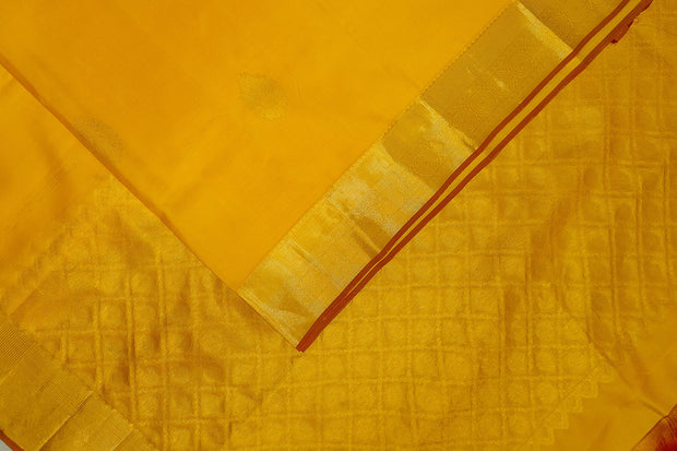 Kanchi pure silk saree in yellow with floral motifs on the body,