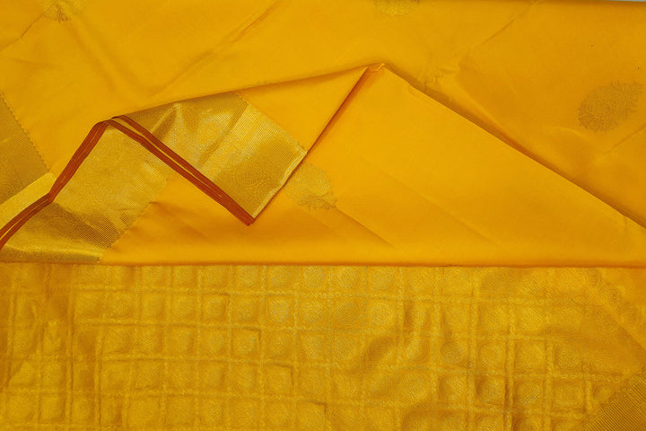 Kanchi pure silk saree in yellow with floral motifs on the body,