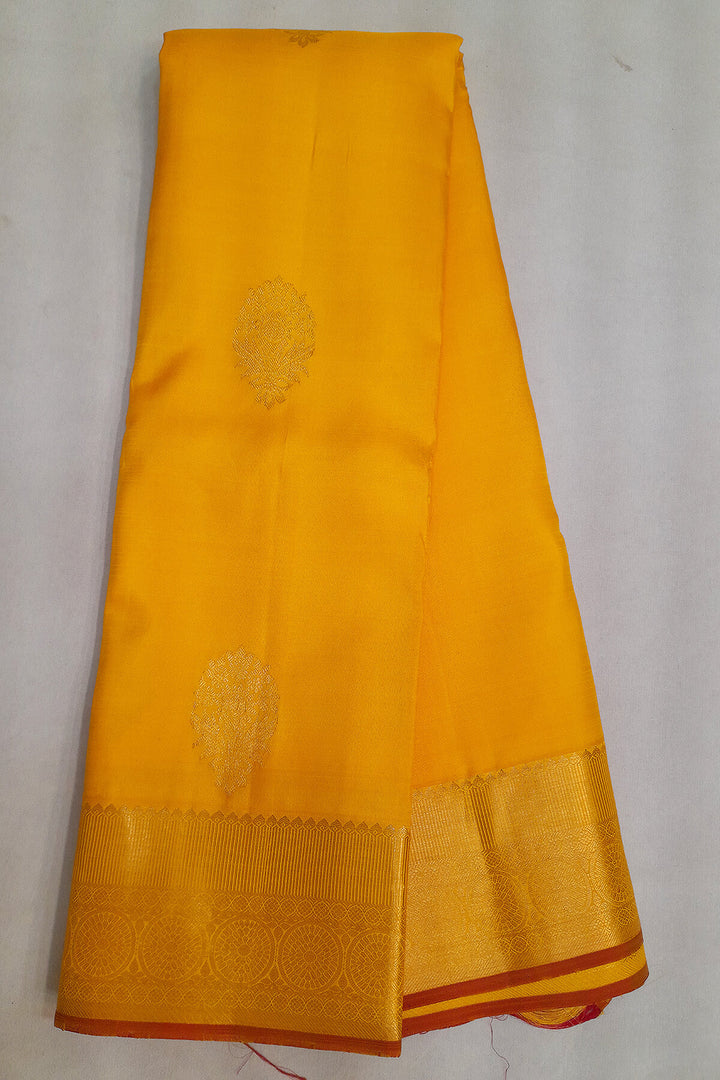 Kanchi pure silk saree in yellow with floral motifs on the body,