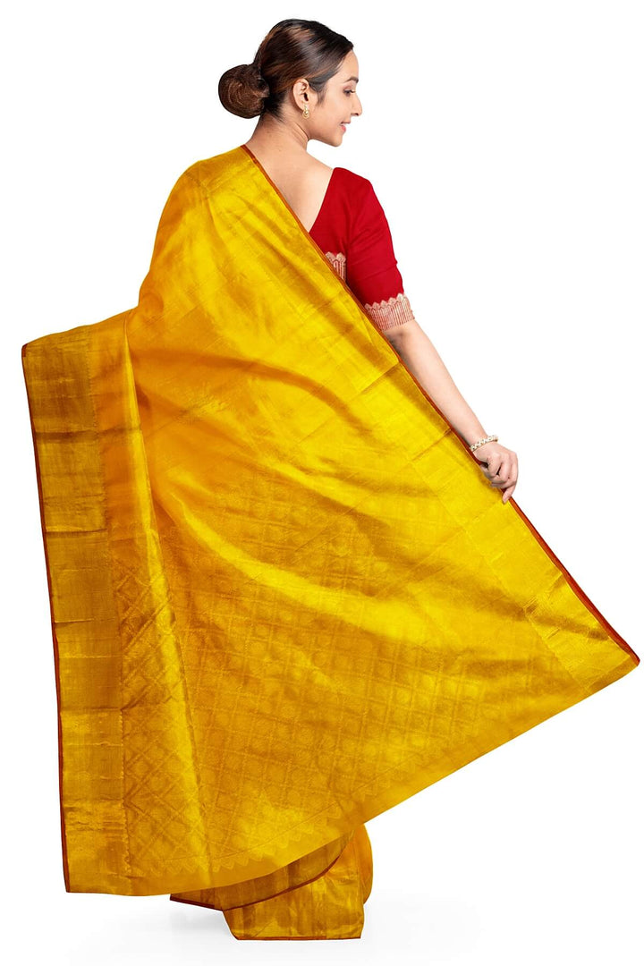 Kanchi pure silk saree in yellow with floral motifs on the body,