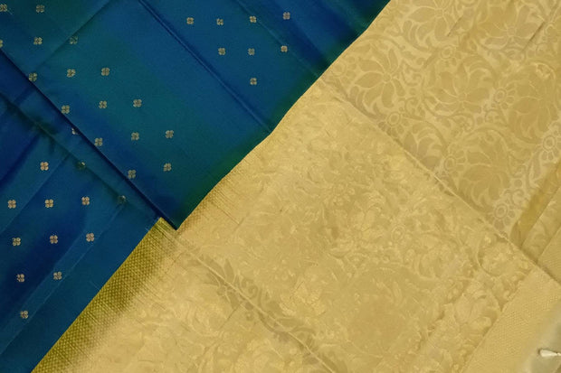 Kanchi soft silk saree in peacock blue with small motifs on the body and floral vines in pallu
