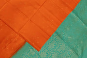 Kanchi soft silk saree in orange with small motifs on the body and floral vines in pallu