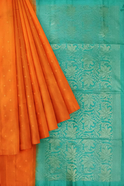 Kanchi soft silk saree in orange with small motifs on the body and floral vines in pallu