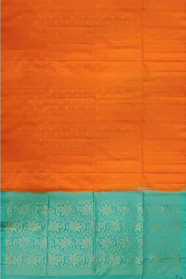 Kanchi soft silk saree in orange with small motifs on the body and floral vines in pallu