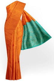 Kanchi soft silk saree in orange with small motifs on the body and floral vines in pallu