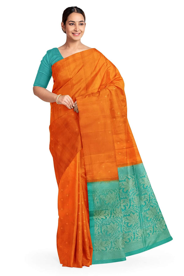 Kanchi soft silk saree in orange with small motifs on the body and floral vines in pallu