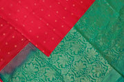 Kanchi soft silk saree in red with small motifs on the body and floral vines in pallu