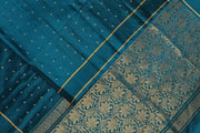 Kanchi soft silk saree in prussian blue with small motifs on the body and floral vines in pallu