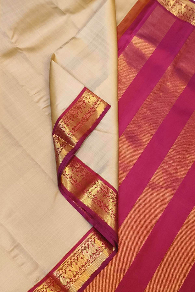 Kanchi pure silk saree in beige with  paisley motifs in the border