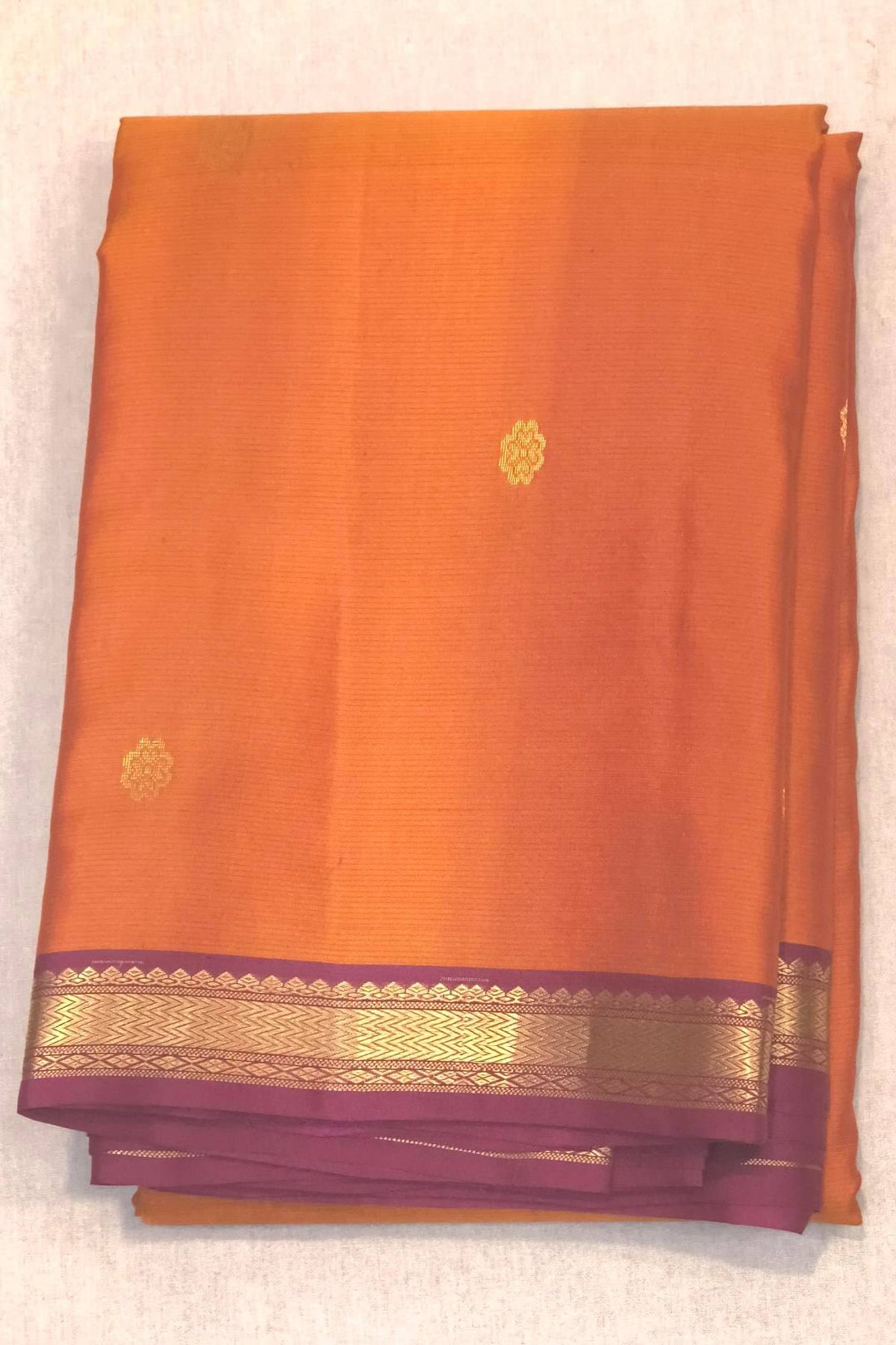 Kanchi pure silk saree in rust colour with small motifs