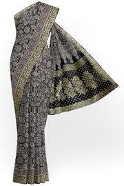 Modal silk saree in black  in hand block ajrakh print with zari border.