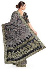 Modal silk saree in black  in hand block ajrakh print with zari border.