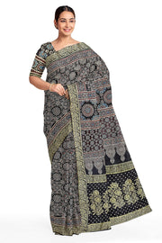 Modal silk saree in black  in hand block ajrakh print with zari border.