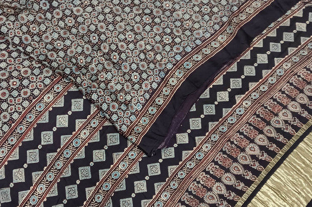 Modal silk saree in black with small motifs  in hand block ajrakh print