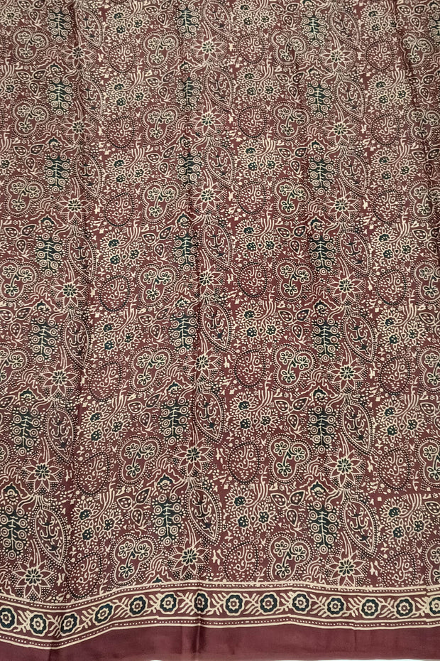 Modal silk saree in maroon with floral motifs  in hand block ajrakh print