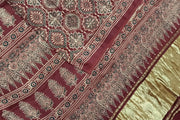 Modal silk saree in maroon with floral motifs  in hand block ajrakh print