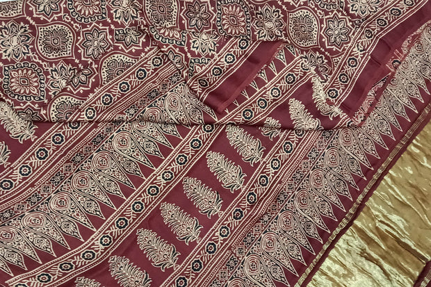 Modal silk saree in maroon with floral motifs  in hand block ajrakh print